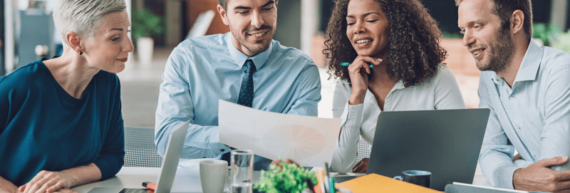 Four healthcare marketers working on paperwork