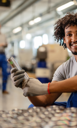 Factory worker holding a pipe