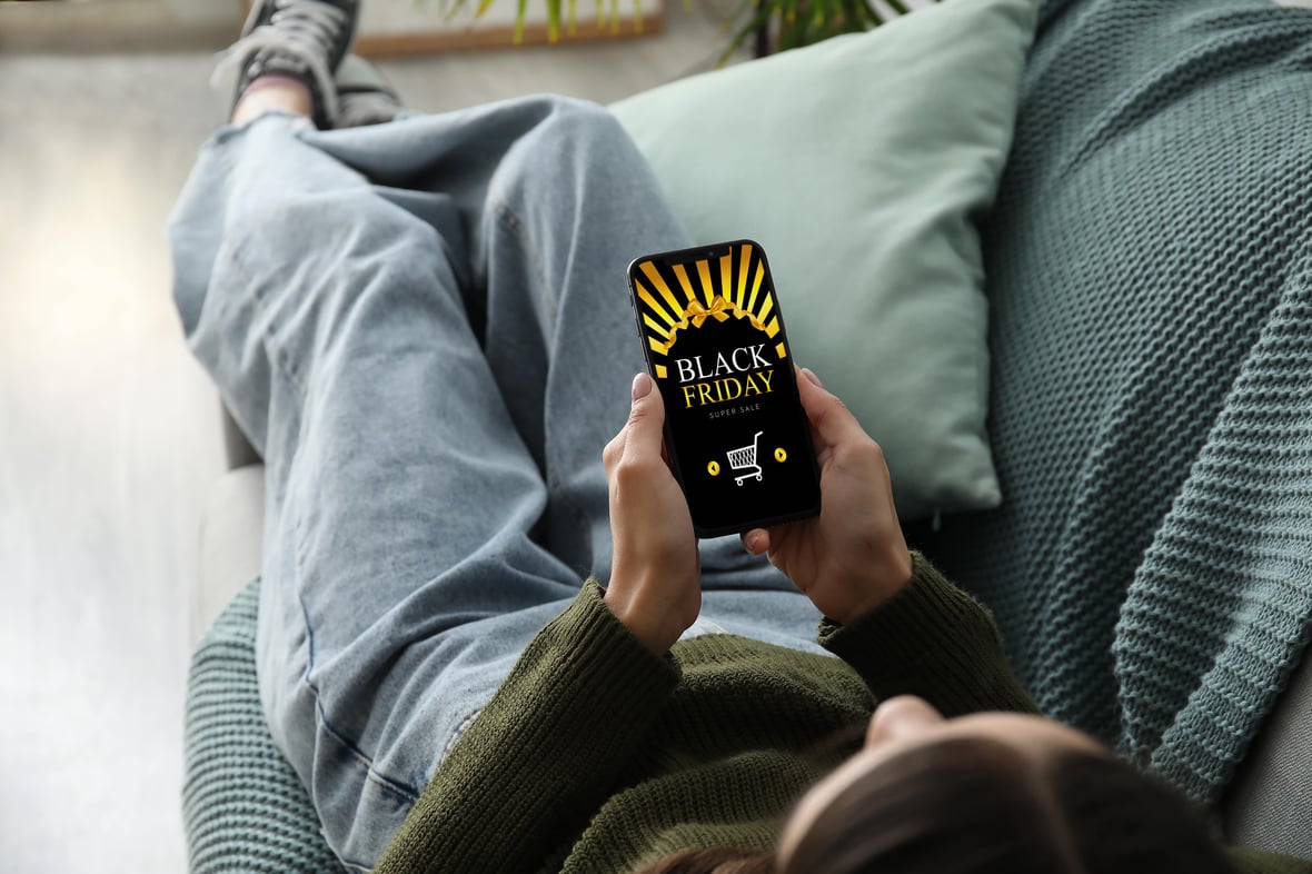 Woman looking at black friday and cyber monday ads on social media