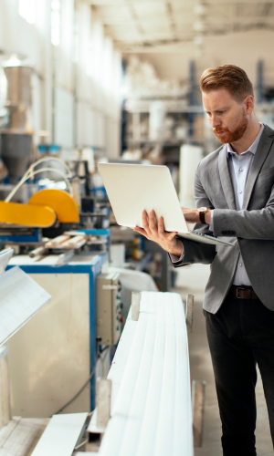 Man holding a laptop while on a fabric