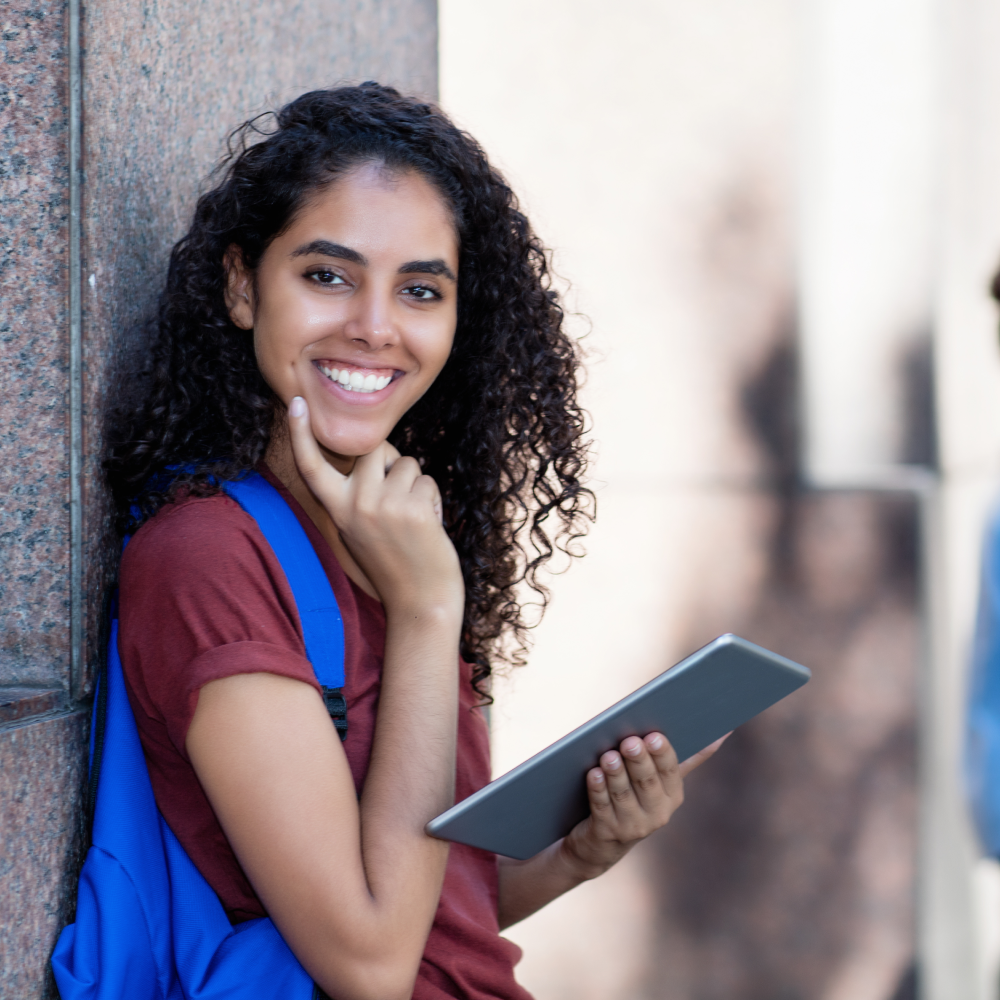 A student smiling and looking at the camera