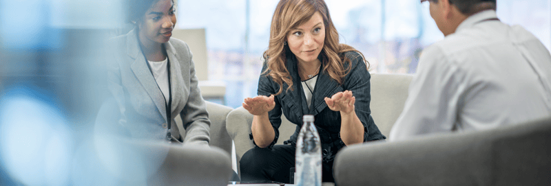 Female marketing leader in a meeting with two employees
