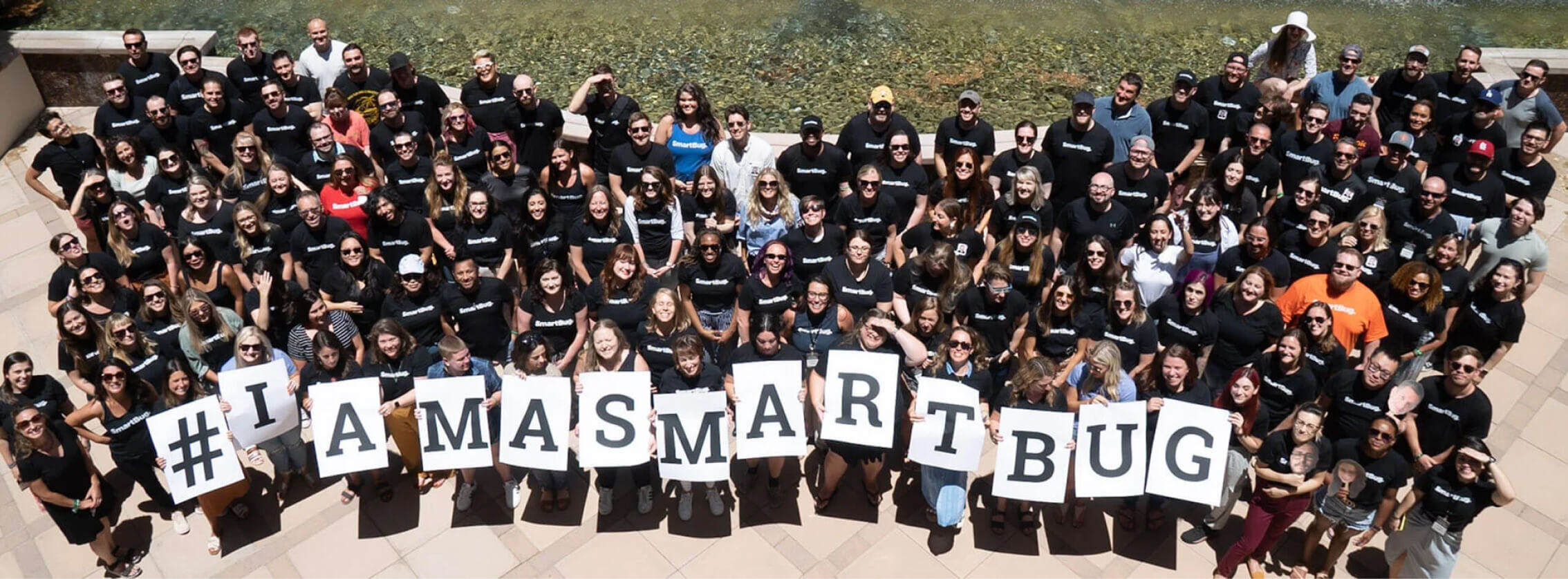 Overhead shot of SmartBugs holding up cards that spell out I AM A SMARTBUG