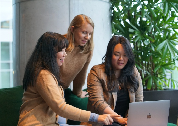 three women working on a computer