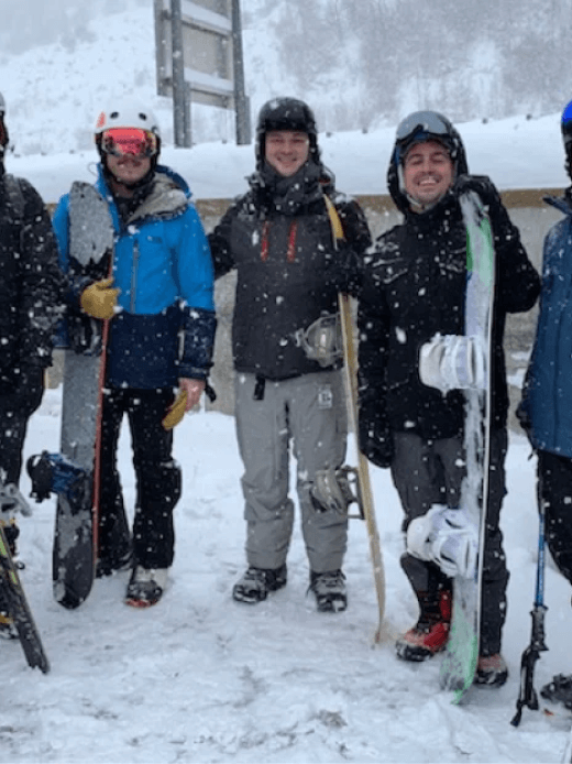 SmartBug employees posing in a photo while snowboarding