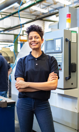 female factory worker smiling at the camera